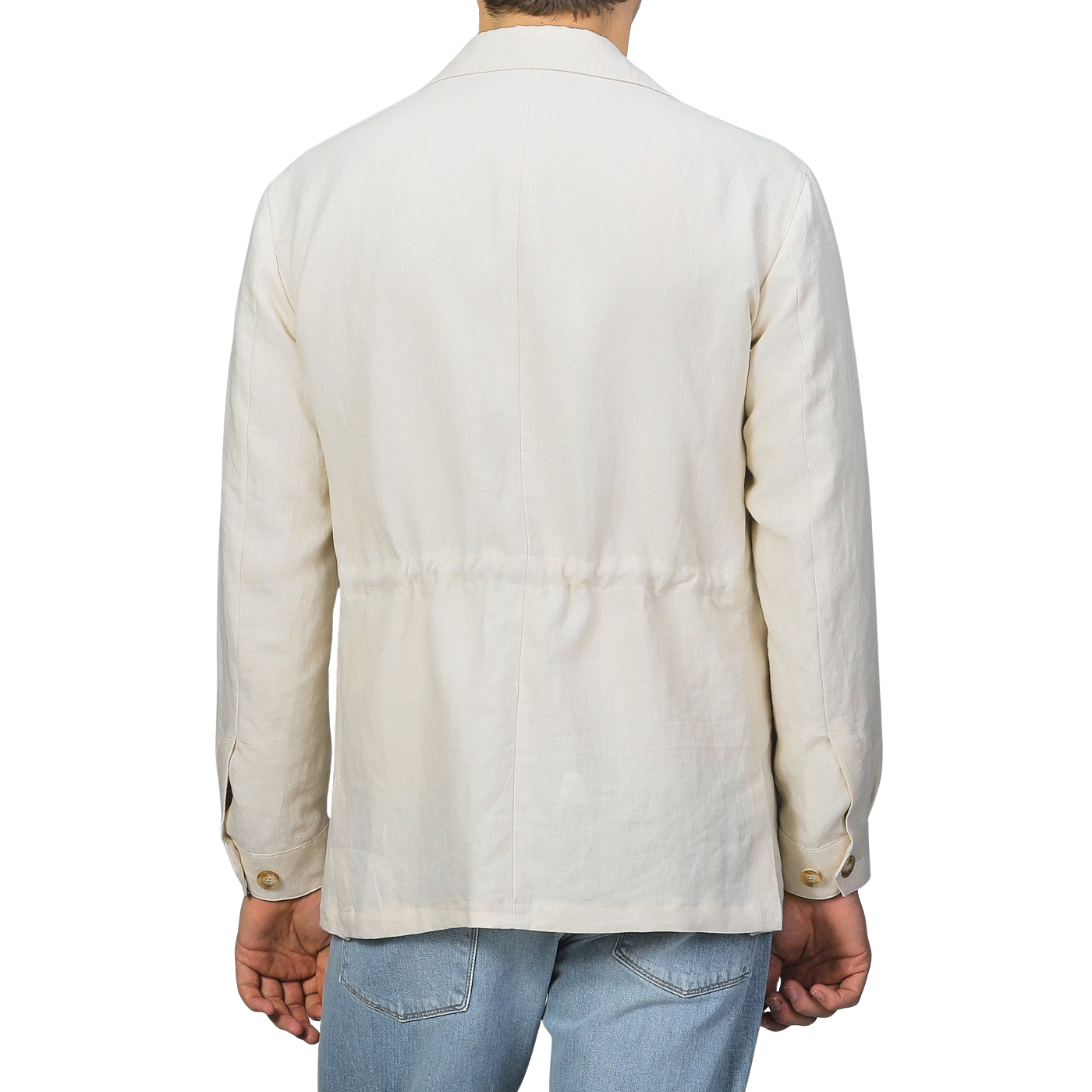 A person is seen from behind wearing a Baltzar Sartorial Light Beige Pure Linen Safari Jacket with blue jeans, exuding effortless style against a neutral backdrop.