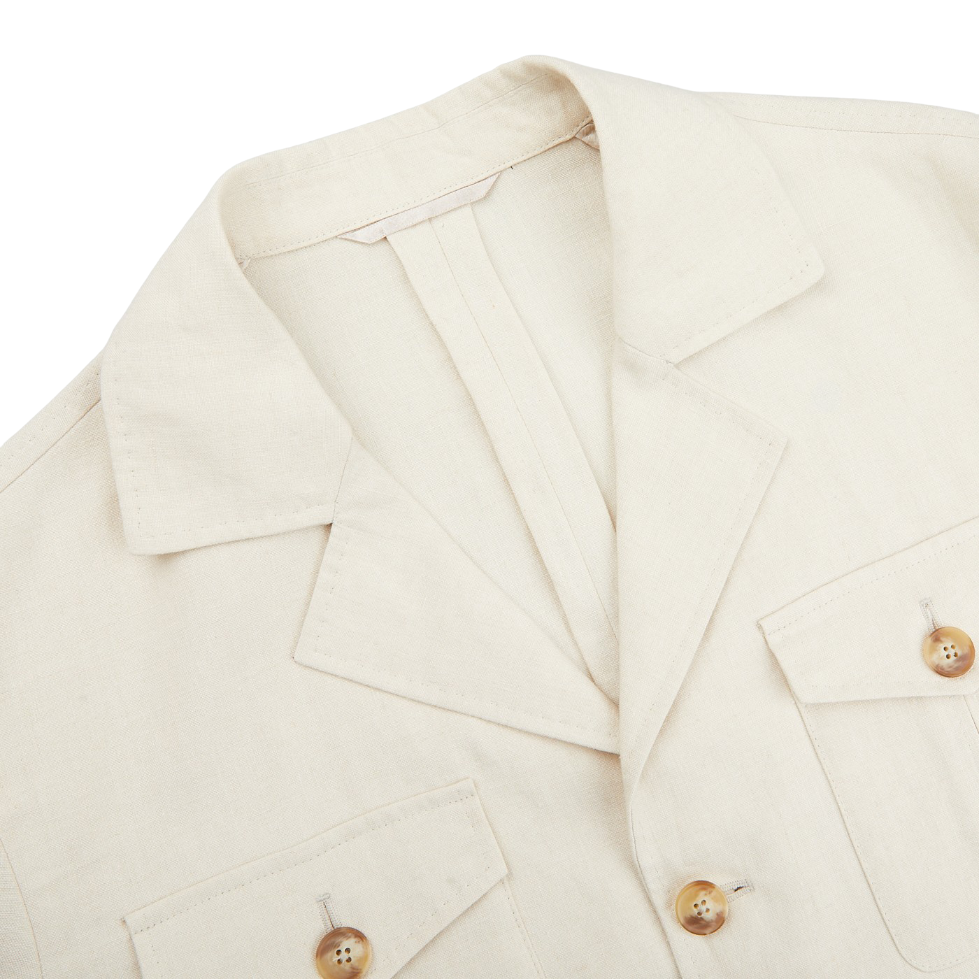 A close-up of the Light Beige Pure Linen Safari Jacket by Baltzar Sartorial, crafted from mid-weight linen with two front pockets and wooden buttons, laid flat on a white surface.