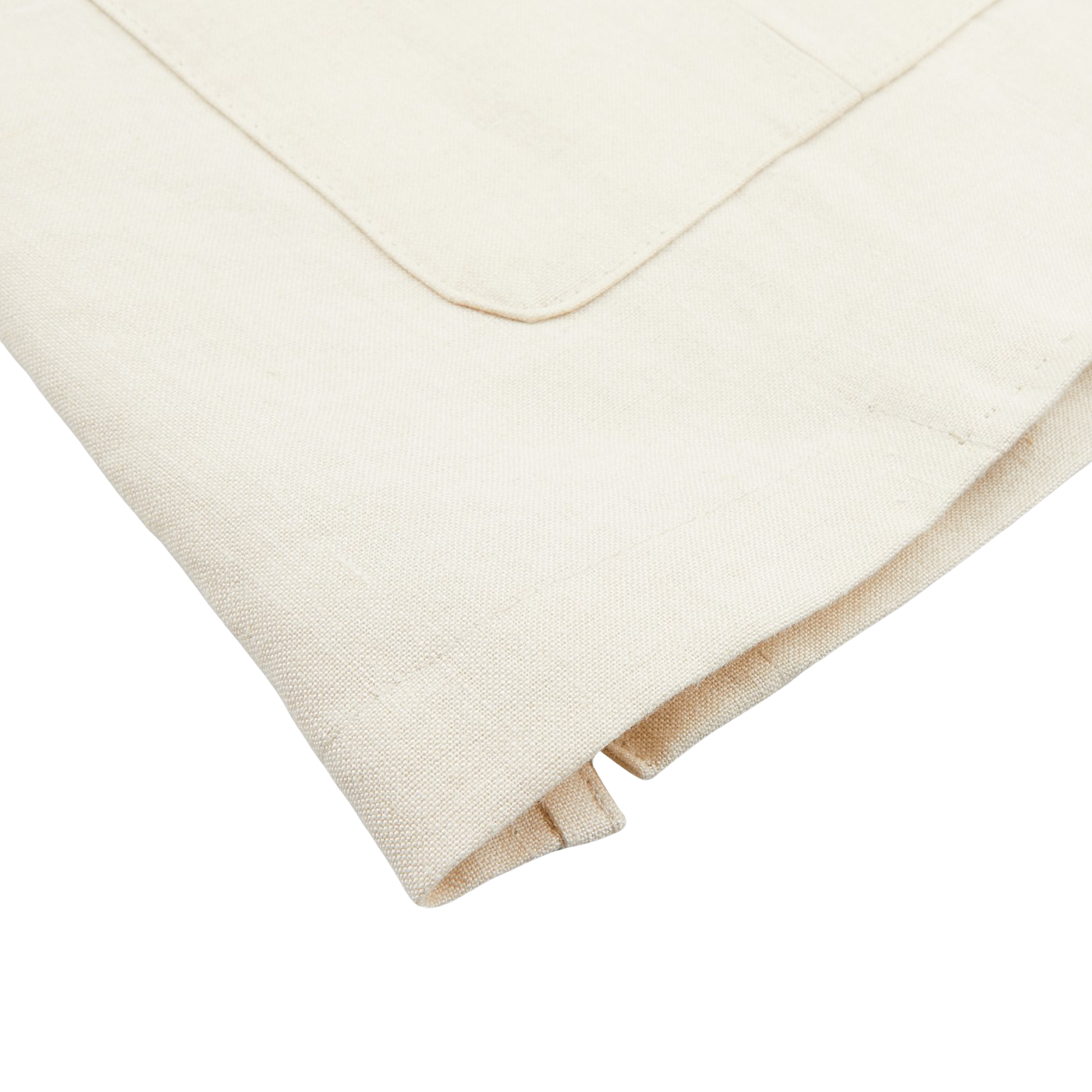 Close-up of a folded Light Beige Pure Linen Safari Jacket by Baltzar Sartorial, showcasing its pocket and seam detailing on a light surface.