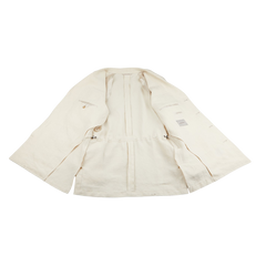 A Light Beige Pure Linen Safari Jacket from Baltzar Sartorial is displayed open on a flat surface, showcasing its interior lining and labels. Crafted from mid-weight linen, it blends elegance with functionality.