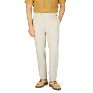 A man wearing Light Beige Pure Linen Trousers by Baltzar Sartorial and a tan shirt.