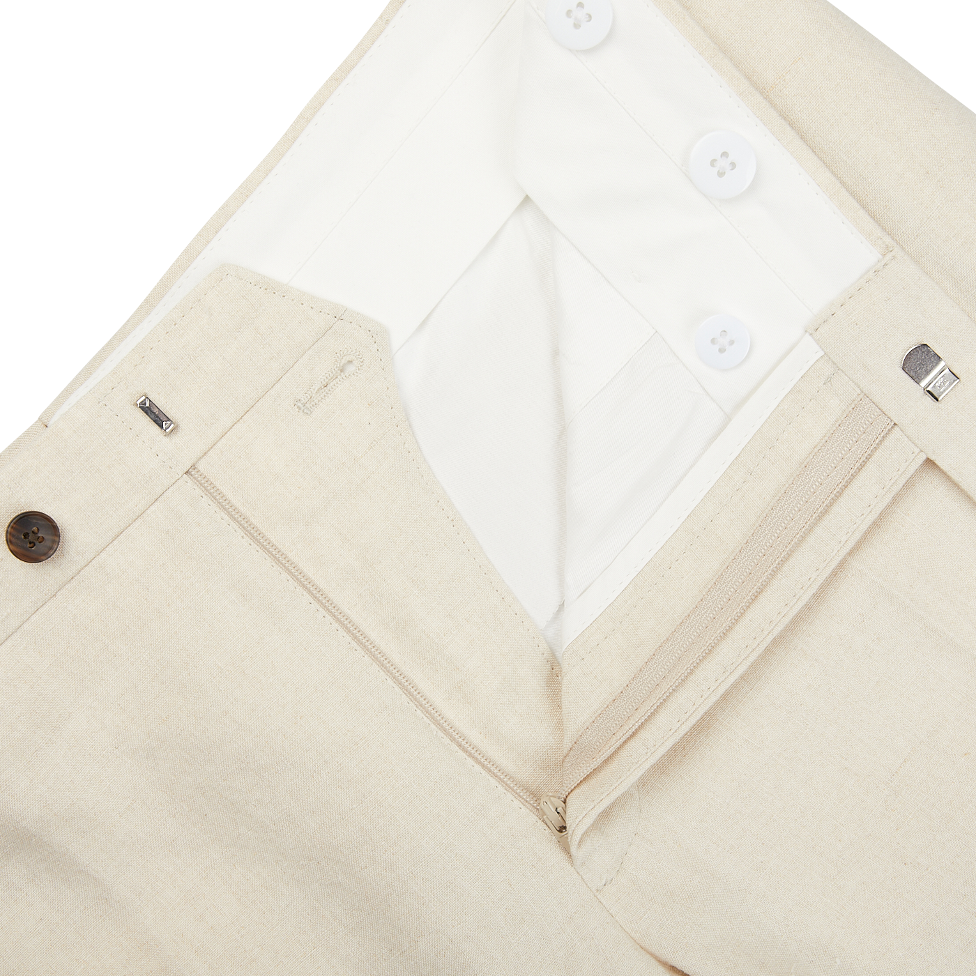 A close up of Light Beige Pure Linen Flat Front Trousers from Baltzar Sartorial with buttons and a tailored fit.