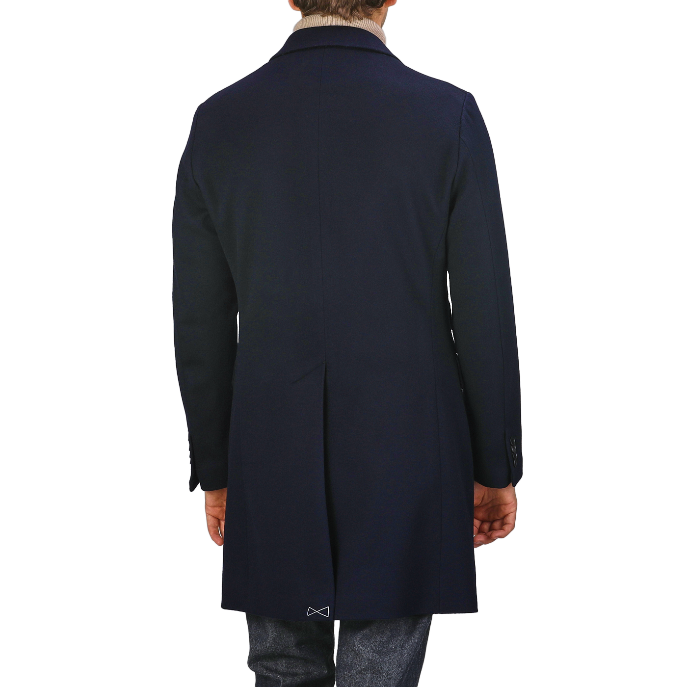 A person wearing a Baltzar Sartorial Navy Blue Loro Piana Wool Tailored Coat and jeans is viewed from the back against a plain background.