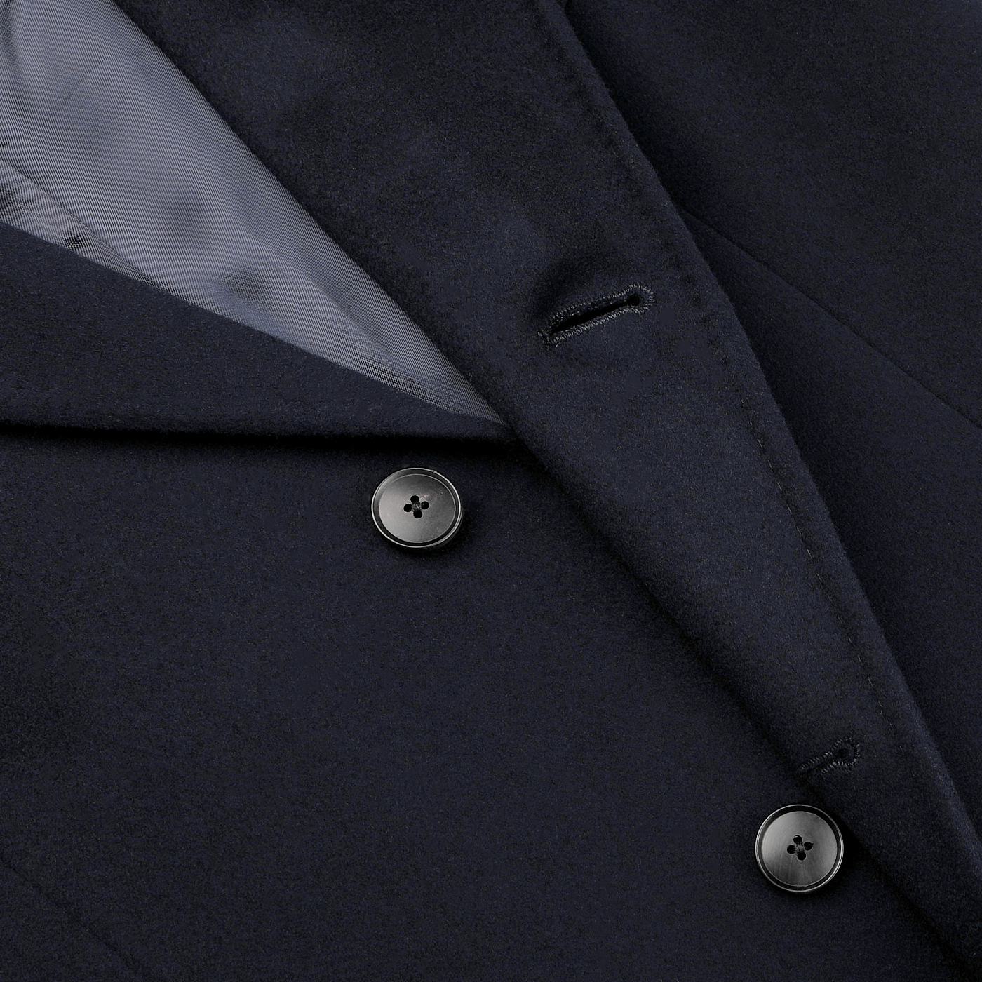 Close-up of the Navy Blue Loro Piana Wool Tailored Coat by Baltzar Sartorial, crafted from pure wool with a visible lining and two buttons.