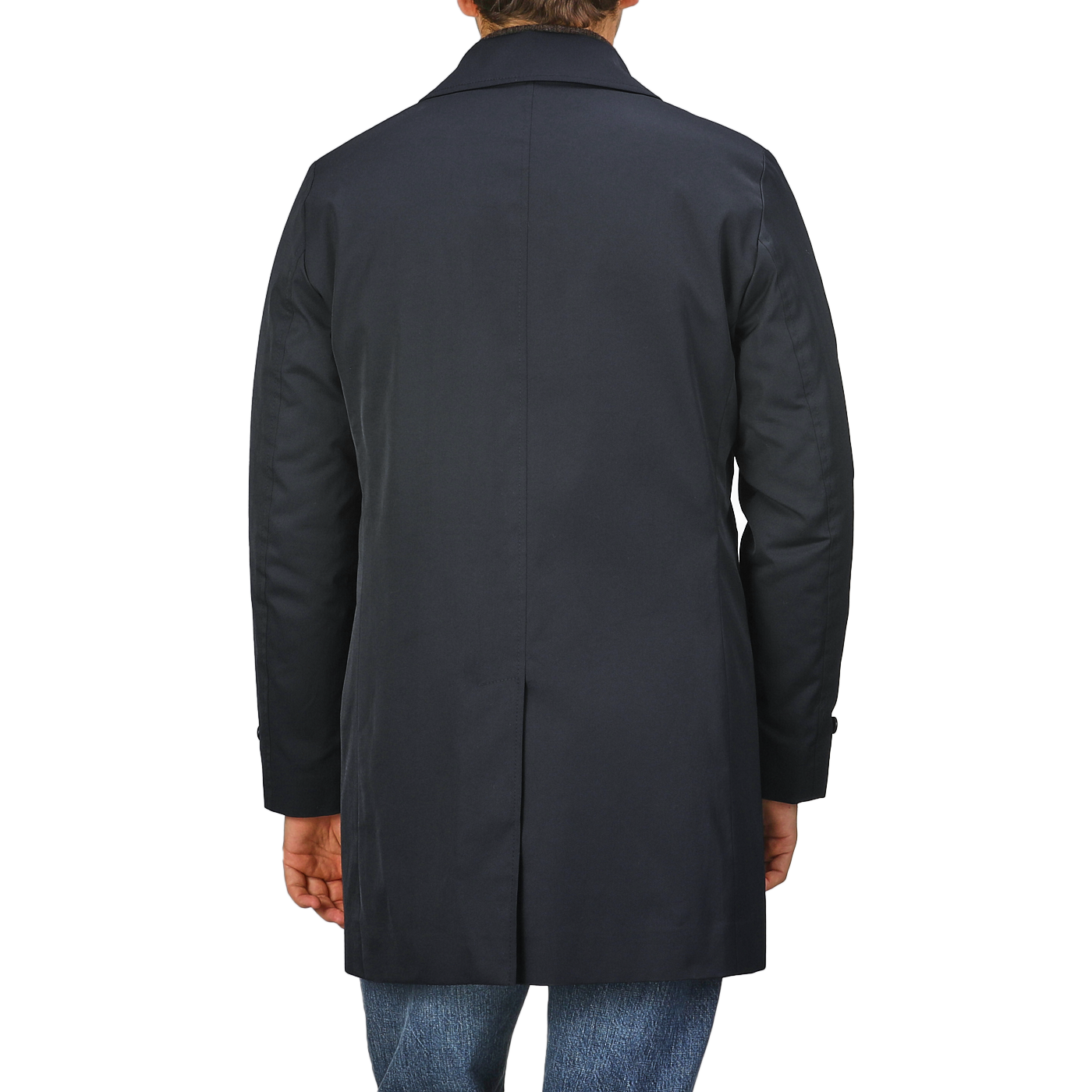 A person is shown from the back wearing the Baltzar Sartorial Navy Blue Nylon Thermore Padded Car Coat paired with blue jeans.