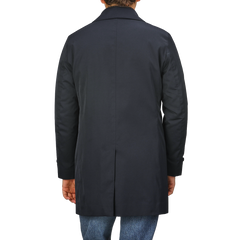 A person is shown from the back wearing the Baltzar Sartorial Navy Blue Nylon Thermore Padded Car Coat paired with blue jeans.