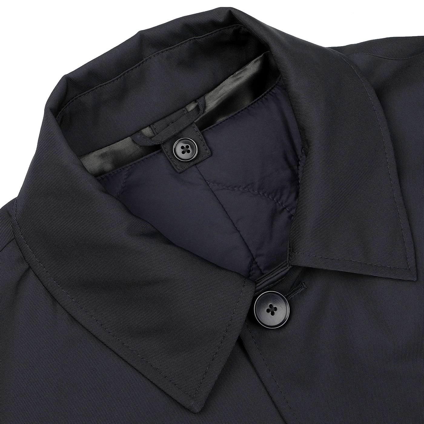 A close-up of a navy blue car coat from Baltzar Sartorial, featuring a collar, the top two buttons, and quilted Thermore Ecodown lining.