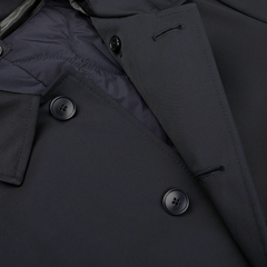 Close-up of the Baltzar Sartorial Navy Blue Nylon Thermore Padded Car Coat, showcasing its dark double-breasted design with four buttons and a quilted Thermore Ecodown lining for enhanced warmth.