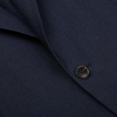 A close up of a Baltzar Sartorial Navy Blue Pure Linen Suit Jacket with a button.