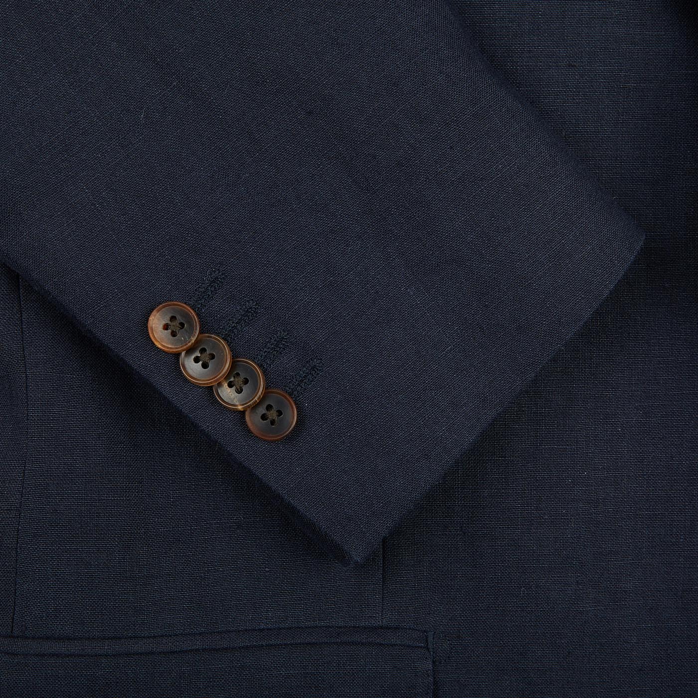 A close up of a Baltzar Sartorial Navy Blue Pure Linen Suit Jacket with buttons.