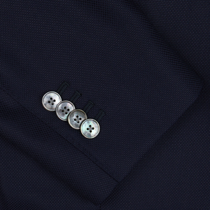 Close-up of a Baltzar Sartorial navy blue wool hopsack blazer sleeve with four buttons.