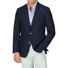 Man wearing a Baltzar Sartorial Navy Blue Wool Hopsack Blazer, striped blue shirt, and white pants.