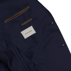 Close-up of a Baltzar Sartorial navy hopsack blazer label and stitching details.