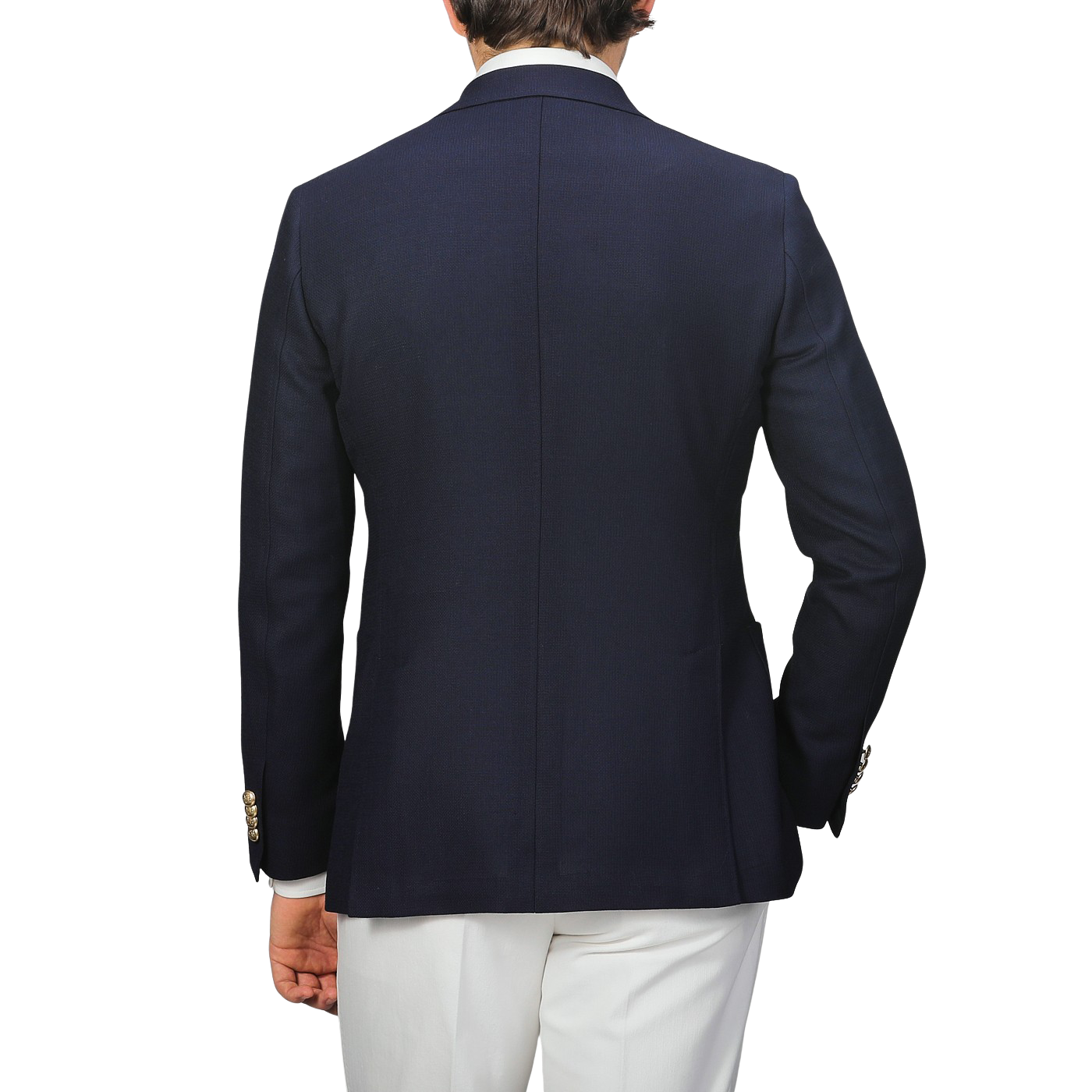 A person showcases timeless elegance from the back in a Baltzar Sartorial Navy Blue Wool Mock Leno DB Club Blazer with white pants against a plain background.