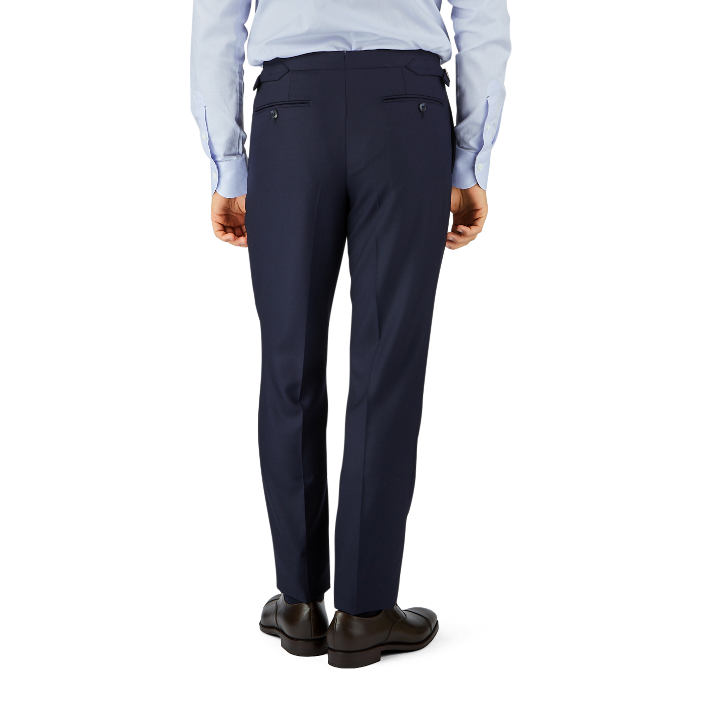 A man wearing a light blue shirt and Baltzar Sartorial Navy Super 100's Wool Flat Front Suit Trousers stands facing away from the camera, hands slightly raised.