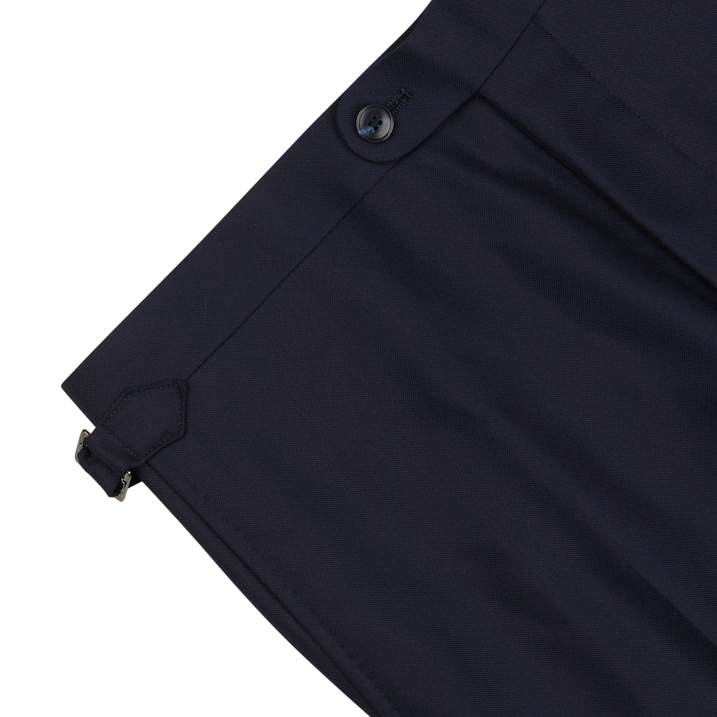 Close-up of a Baltzar Sartorial Navy Super 100's Wool Flat Front Suit Trousers waistband with a button closure and a metal clasp detail on a white background.