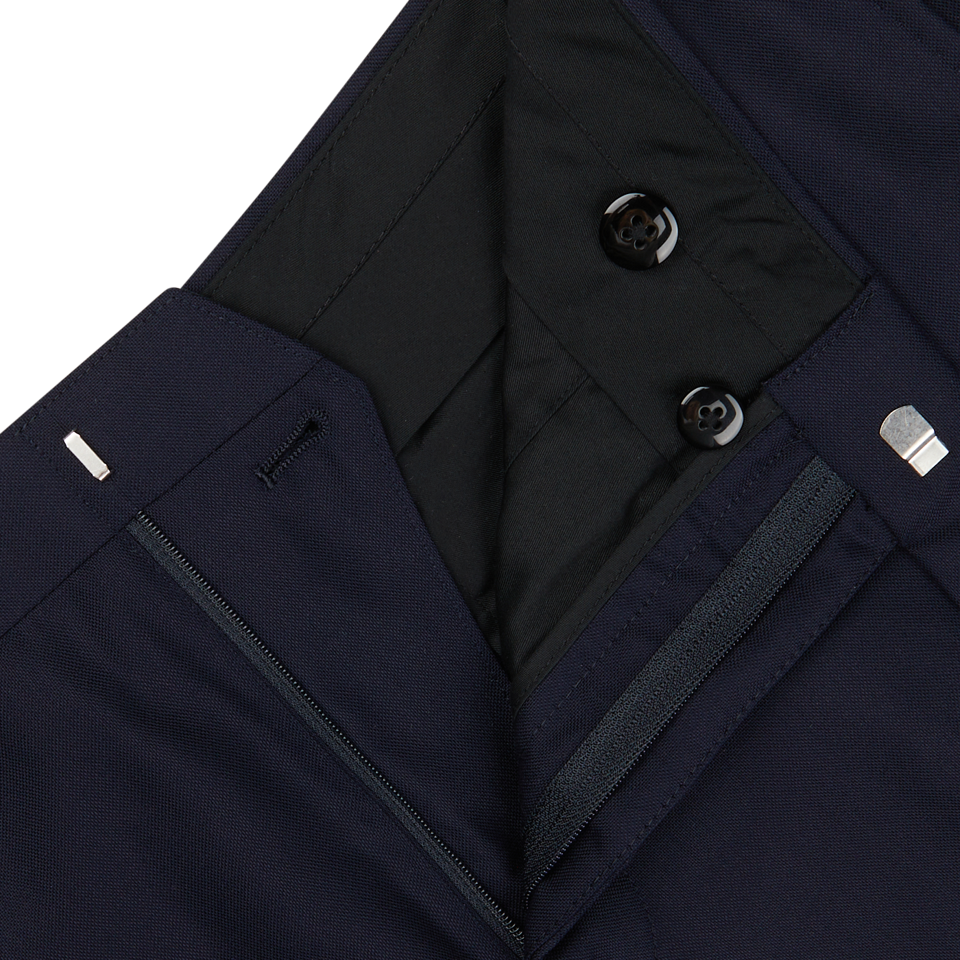 Close-up of a Baltzar Sartorial dark navy blue jacket with zipper and button details, featuring tailored seams and quilted lining.