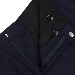 Close-up of a Baltzar Sartorial dark navy blue jacket with zipper and button details, featuring tailored seams and quilted lining.