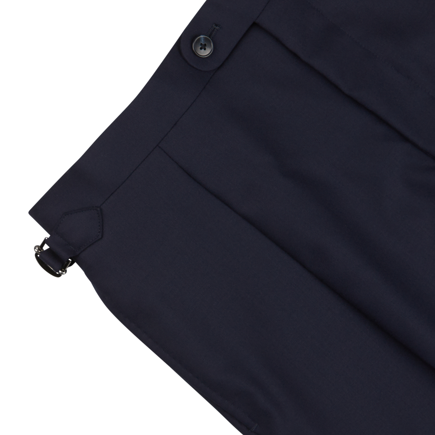 Close-up of a Baltzar Sartorial navy blue pleated skirt with a side button and a small buckle detail, crafted from super 100’s wool.