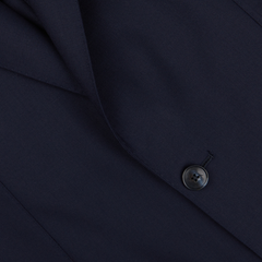 Close-up of a Baltzar Sartorial navy Super 100's wool suit jacket detail showing fabric texture and a button.