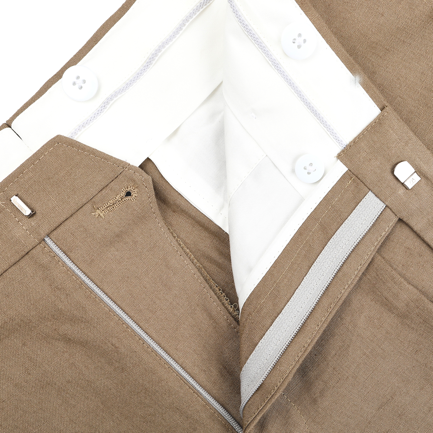 Close-up of the Taupe Beige Pure Linen Pleated Trousers by Baltzar Sartorial with tailored fit, white waistband, button fastenings, and zipper.