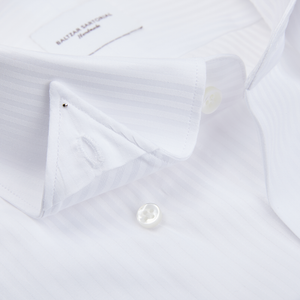 A close-up of a White Striped Cotton Dinner Handmade Shirt by Baltzar Sartorial with mother-of-pearl buttons.