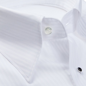 A close-up of a White Striped Cotton Dinner Handmade Shirt with mother-of-pearl buttons by Baltzar Sartorial.