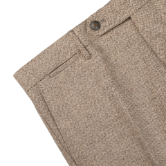 Close-up of Berwich Beige Herringbone Wool Tweed Trousers, showcasing the waistband, button closure, and belt loops against a white background.