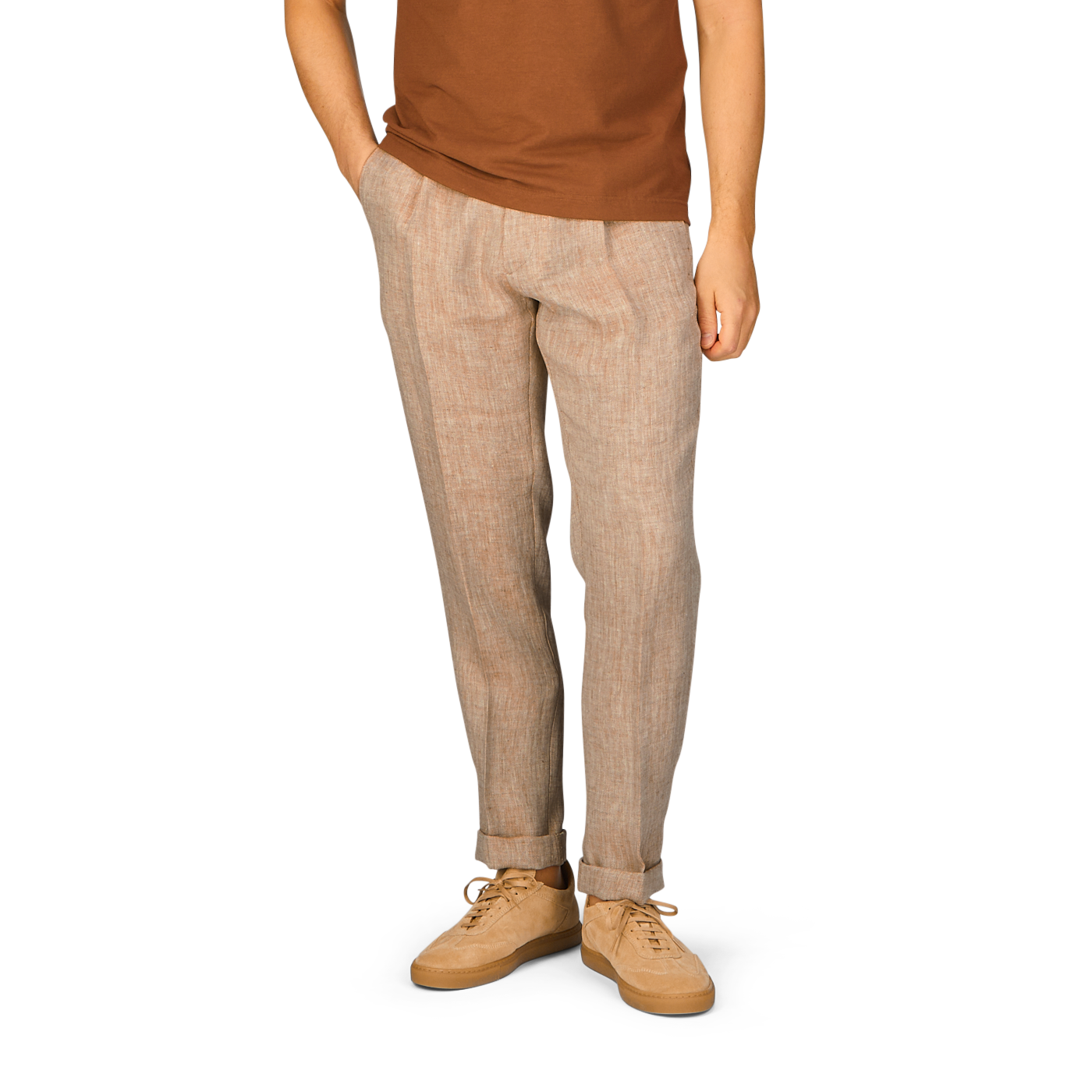 A man wearing a tan t-shirt and Berwich brown linen trousers.