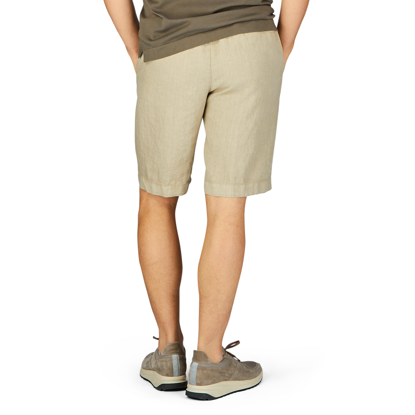 Person standing with their back to the camera, wearing contemporary fit Berwich Beige Washed Linen Drawstring Shorts and gray sneakers.