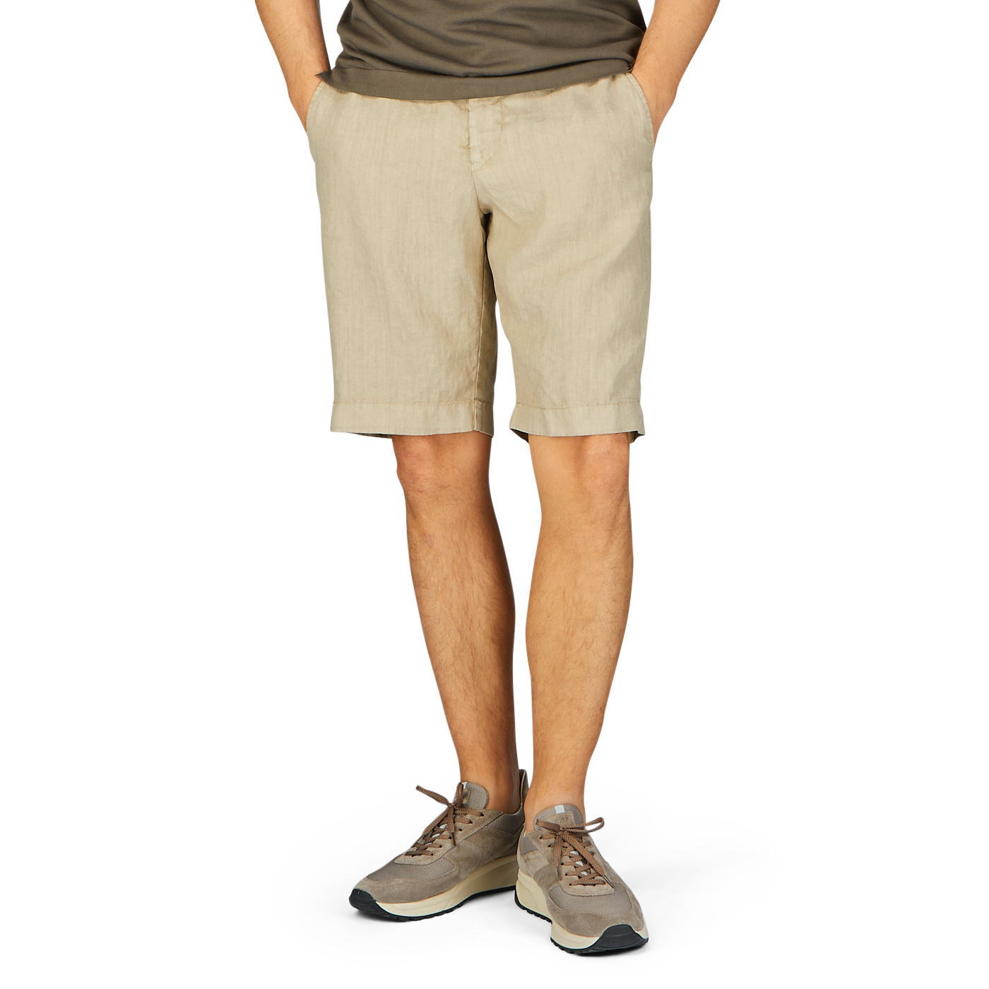 Person wearing contemporary fit, Berwich beige washed linen drawstring shorts and casual sneakers standing against a plain background.