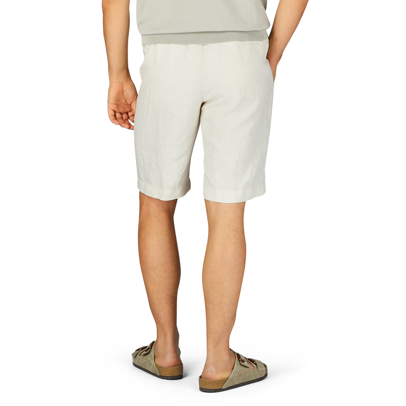 A person standing in Berwich cream beige washed linen drawstring shorts and casual shoes, viewed from the waist down.