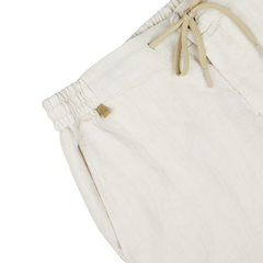 Close-up of a Berwich cream beige washed linen drawstring shorts' waistband with a metal brand tag.