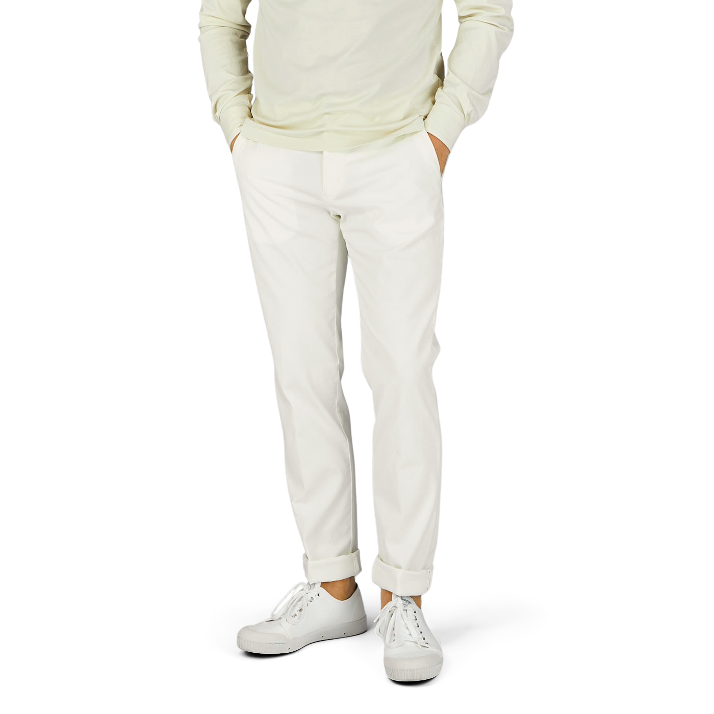 A man wearing Berwich cream white cotton stretch chinos and a green sweater.