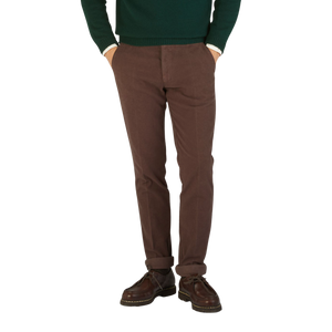 A man wearing Berwich Dark Brown Cotton Moleskin Chinos and a green sweater.