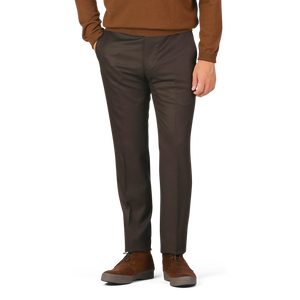 A person in a brown sweater and Berwich Dark Brown Wool Flannel Flat Front Trousers stands with hands in pockets, wearing brown shoes.