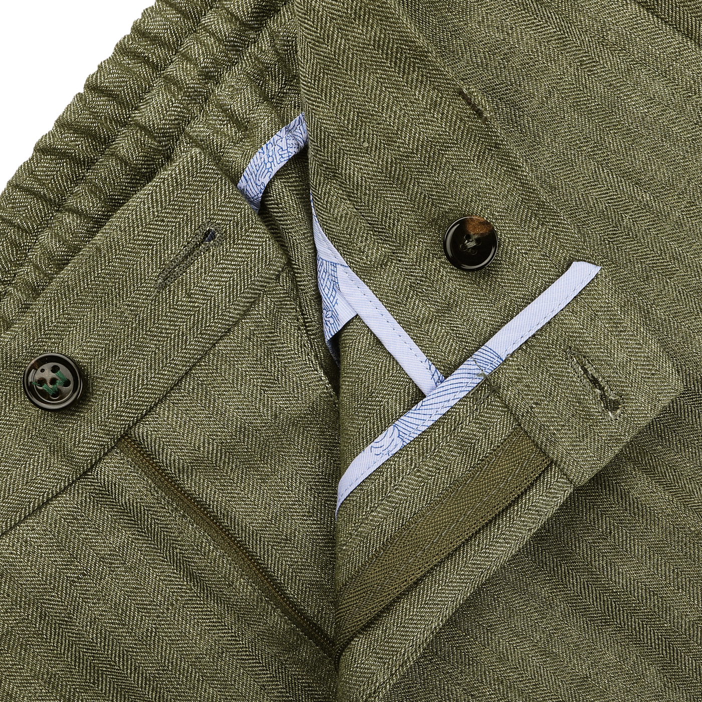 Close-up of Berwich's Green Linen Herringbone Drawstring Trousers featuring a slim fit, buttoned waistband, and partially open zipper that reveals a hint of blue inner lining.