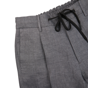 A pair of slim fit Grey Linen Herringbone Drawstring Trousers by Berwich with black ties.
