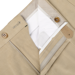 Close-up of khaki beige cotton moleskin trousers with a partially open zipper and button closure, revealing a "Berwich" label on the inner waistband. The Vulcano fit enhances the silhouette, offering comfort and style.