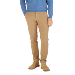 A man wearing a blue sweater and Berwich Light Beige Cotton Moleskin Chinos.