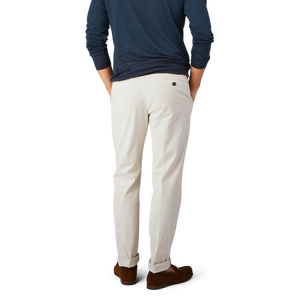 The man is wearing Light Beige Cotton Stretch Chinos by Berwich and a blue shirt.