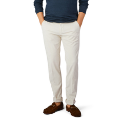 A man in slim fit Light Beige Cotton Stretch Chinos from Berwich and a blue cotton shirt.