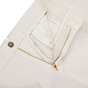 A pair of Berwich Light Beige Cotton Stretch Chinos with gold zippers.