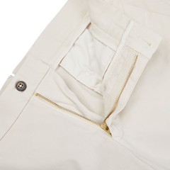 A pair of Berwich Light Beige Cotton Stretch Chinos with gold zippers.