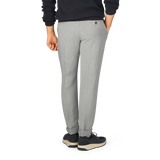 The back view of a man wearing Light Grey Linen Blend Flat Front Trousers and a black sweater by Berwich.