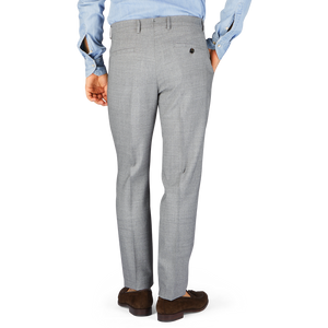 A man in Berwich Light Grey Wool Fresco Flat Front Trousers, high-twist wool fabric, seen from behind.