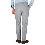 A man in Berwich Light Grey Wool Fresco Flat Front Trousers, high-twist wool fabric, seen from behind.