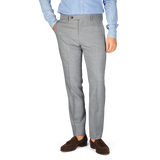 A man in a blue shirt and grey Berwich Light Grey Wool Fresco Flat Front Trousers.