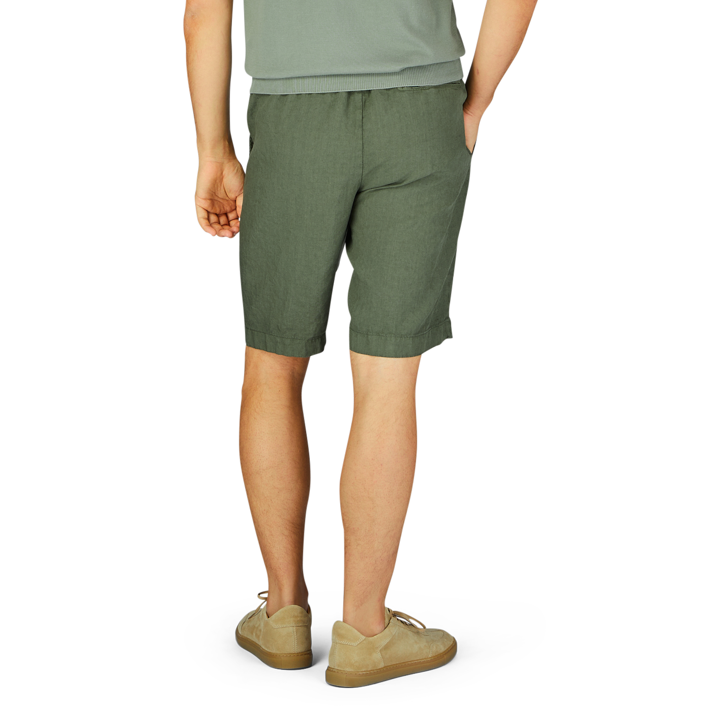Person wearing Berwich militare green washed linen drawstring shorts and beige slip-on shoes standing with their back to the camera.