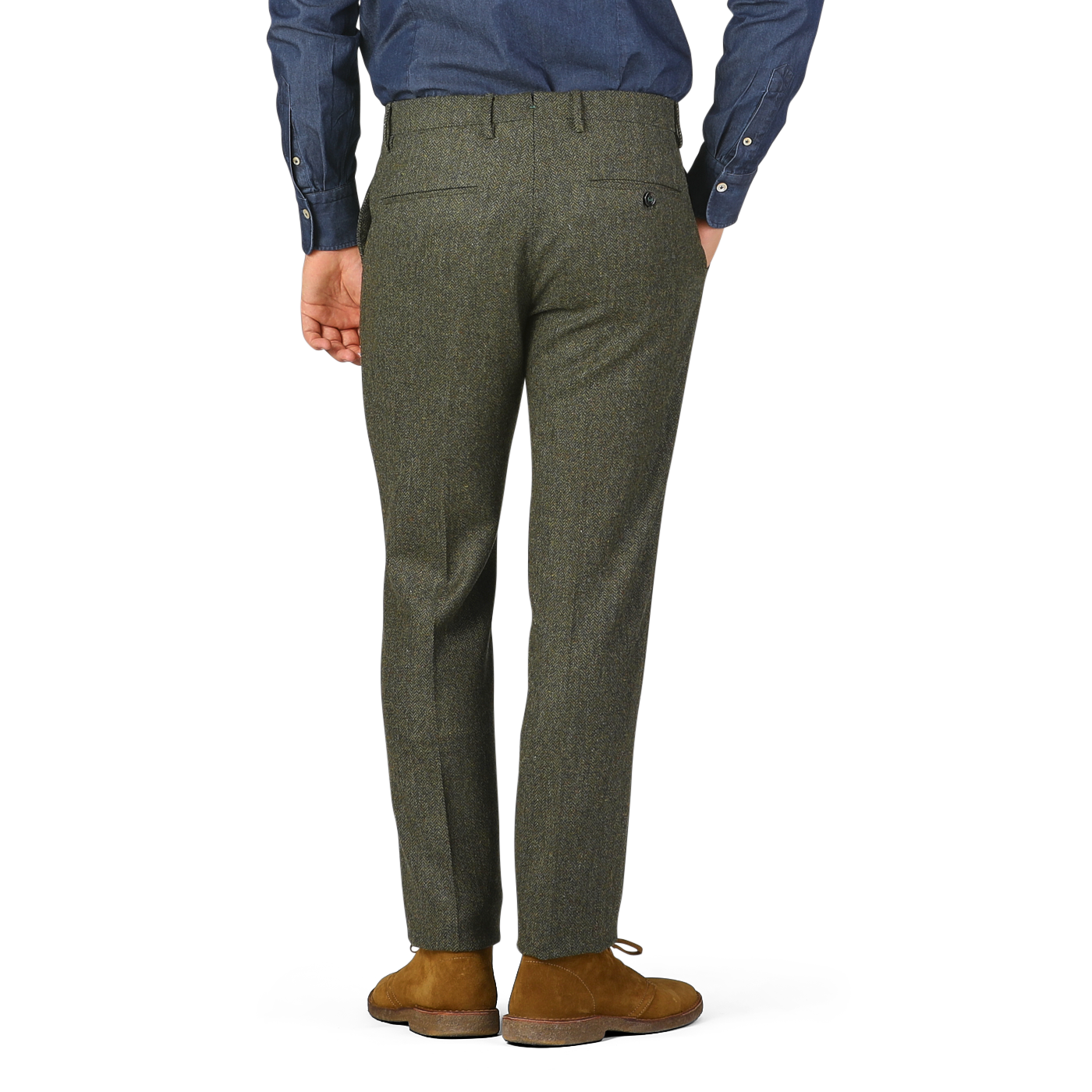 A person wearing Berwich Moss Green Herringbone Wool Tweed Trousers and brown suede shoes is shown from the back, with hands relaxed at their sides, against a plain background.